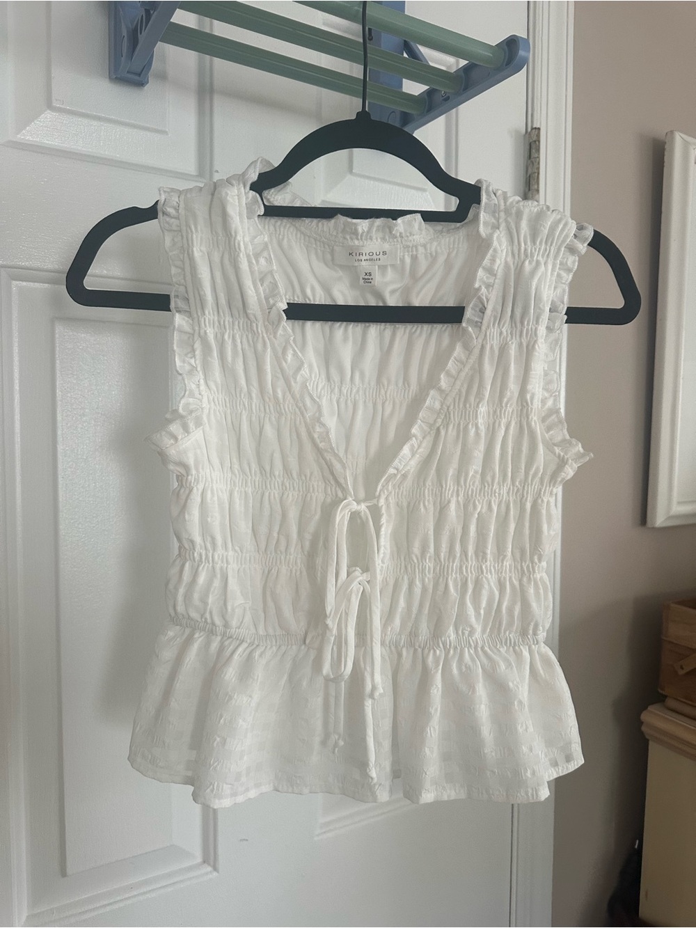 White Sleeveless Smocked Tie-Front Peplum Top